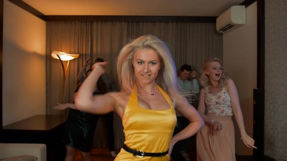 Woman Dancing at Party. Pretty Cheerful Blond Girl in Yellow Dress Dance on Friend's Birthday.