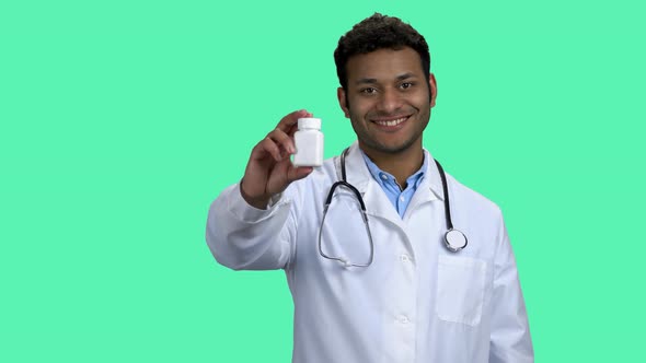 Smiling Male Doctor Showing Pills and Thumb Up.