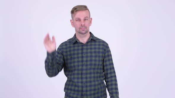 Portrait of Happy Blonde Hipster Man Waving Hand