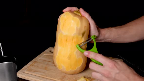 Locked Off View Of Peeling Skin Off Butternut Pumpkin With Vegetable Peeler