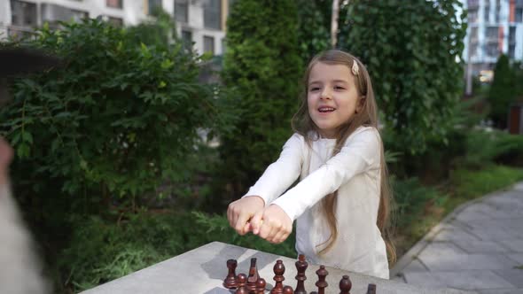 Cute Girl Offers to Choose the Color of Chessman