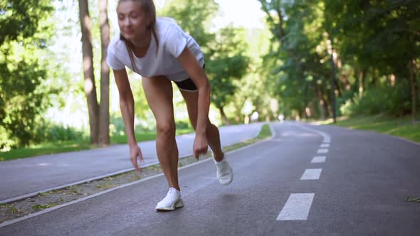 Running From Low Start. The Athlete Runs Along the Treadmill. Slow Motion.