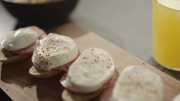 Slow Motion Handheld Shot of Small Canapes with Salami and Mozzarella on Baguette Slices with Pesto