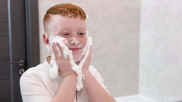 Funny Boy in the Bath Smears His Face with Shaving Cream the Child Imitates an Adult Dad Shaves