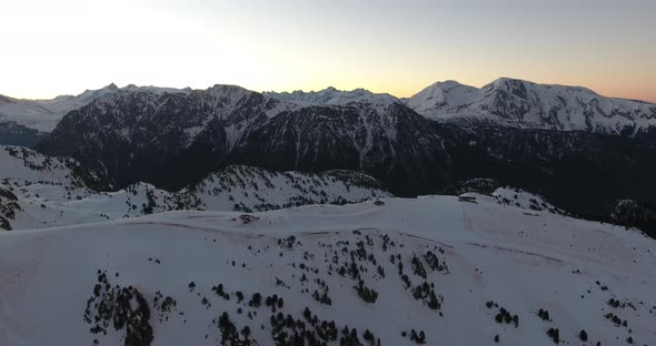 Chamrousse French alps during sunrise above the main ski tracks, Aerial flyover shot