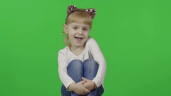 Girl in Jeans and Headband with a Cat Ears. Happy Four Years Old Child. Chroma