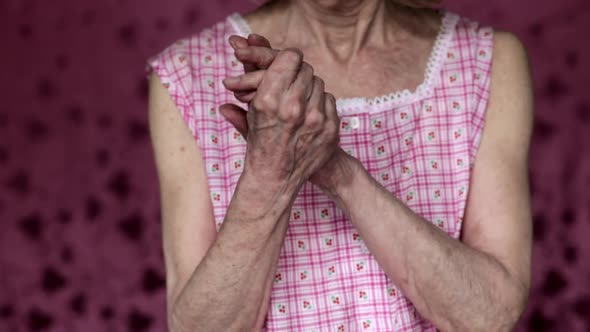 Close up of senior woman rubbing hands