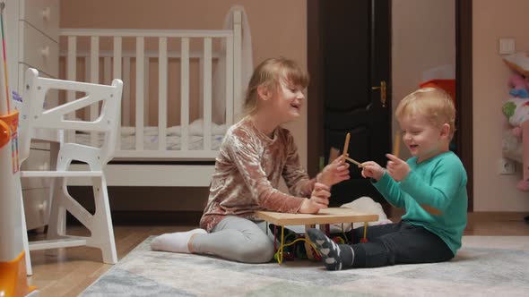 Little Girl And Boy Drumming