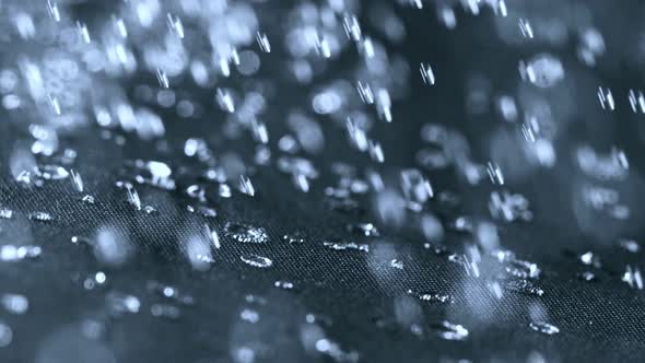 Super Slow Motion Shot of Water Splashing on Waterproof Cloth at 1000Fps