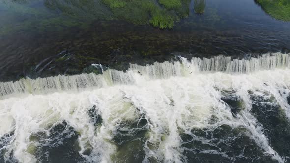 Jumping Fish On Artificial Waterfall Cliff. Fisherman Dream To Catch Salmon Fish By Naked Hands.