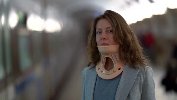 Portrait of a Middle-aged Woman in a Jacket, She Is in the Subway, She Has a Corset Around Her Neck.