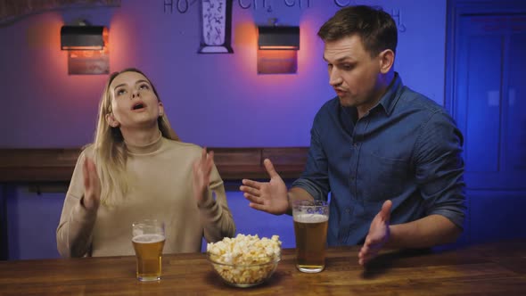 Young Couple Quarrel in a Bar