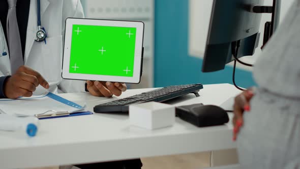 Doctor Holding Digital Tablet with Horizontal Greenscreen