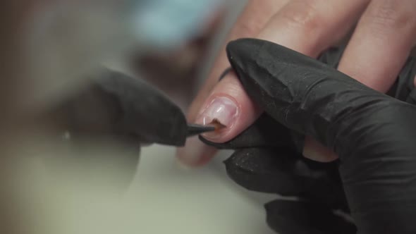 Manicurist Builds Up the Nails of a Female Hand Part1