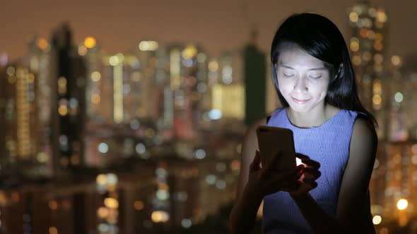 Woman use of cellphone at night