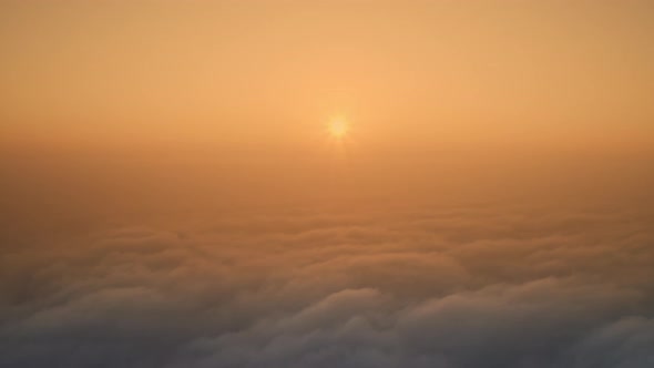 Dawn Sun Over Thick Misty Clouds