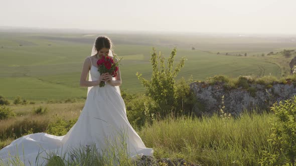 Slow Motion of Bride That Holds Her Red Bouquet of Roses