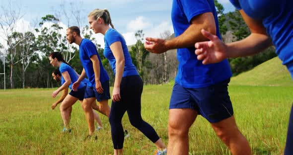 Fit people jogging in boot camp 4k