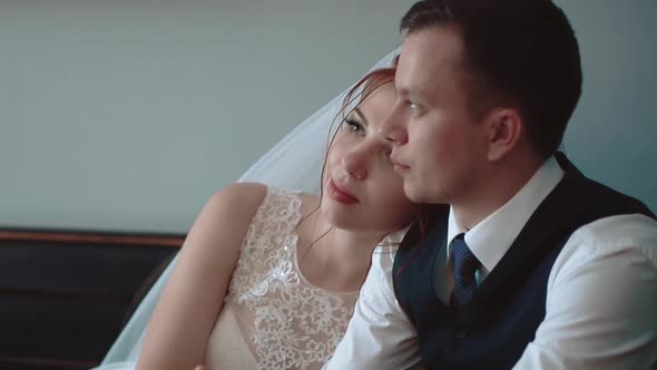 Newlyweds Sitting in a Cafe and Looking Out the Window Closeup Slow Motion