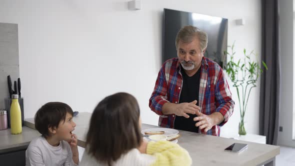 Grandparent with Grandkids Talking in the Kitchen