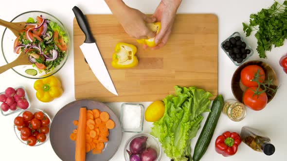 Woman Cutting Pepper in Half and Removing Seeds