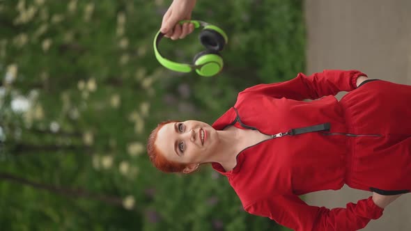 Girl Looks at Headphones