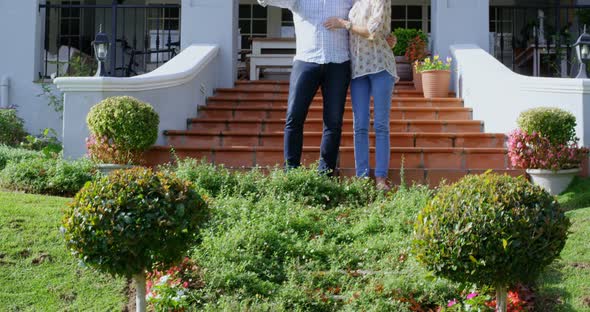 Senior couple taking selfie in homeyard 