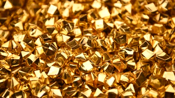 Abstract background of golden nuggets spinning