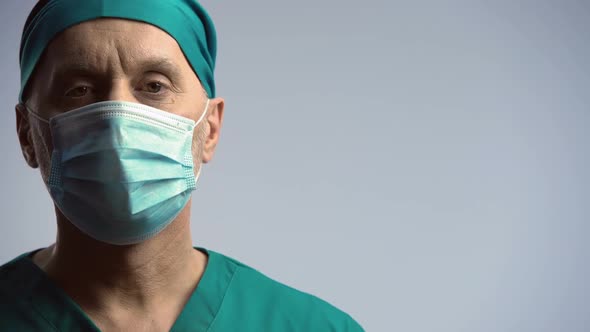 Serious Face of Male Physician Looking to Camera, Warning on Epidemic, Medicine