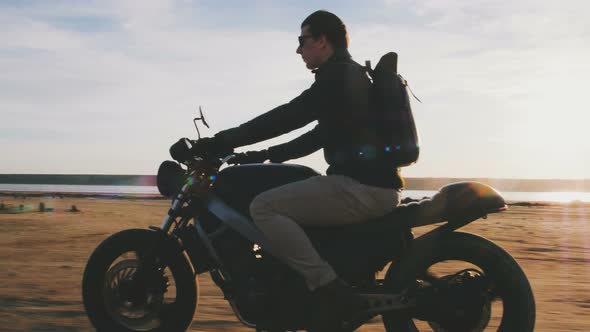 Motorcyclist Driving His Motorbike on the Road During Sunset