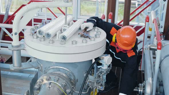 A Mechanic Removes Large Wrenches After Repairing Gas Equipment