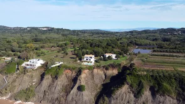 Spectacular aerial drone flight fly forwards drone shot on a sunny day time of a house with pool on