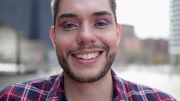 Gay Man Wearing Making Makeup Smiling at Camera Outdoor  Nonbinary and LGBT Pride Concept