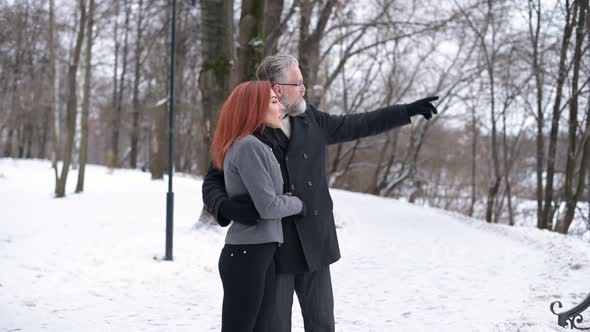 Husband and wife walk in the park and enjoy the views, contemplate the landscape