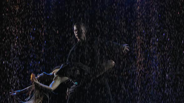 A Passionate Latin American Bachata Dance Performed By a Lovely Couple. Silhouettes in Drops of Rain