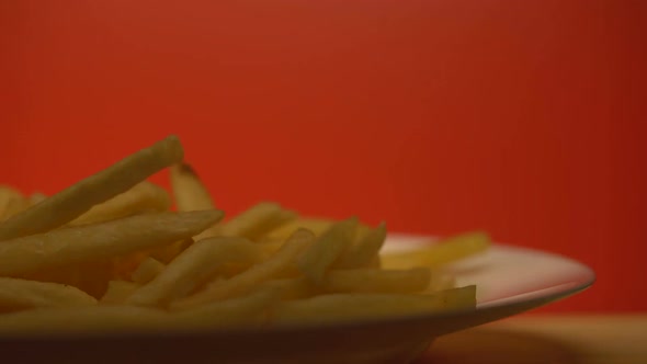 Crispy French Fries Illuminated on Red Background