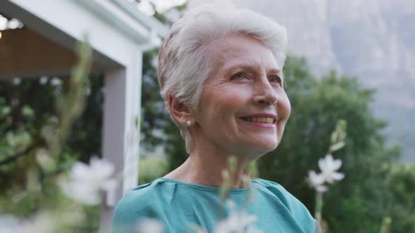 Senior Caucasian woman smiling and spending time in the garden
