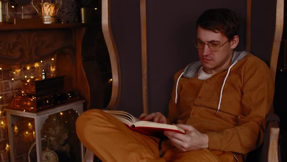 Young Man in Glasses Reading Book