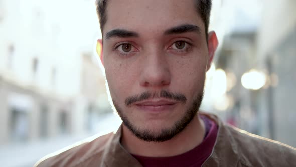 Authentic Shot of Hipster Young Man Looking and Smiling at Camera