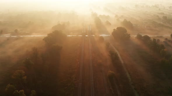 Railway Track at Sunrise in the Fog. View From the Drone