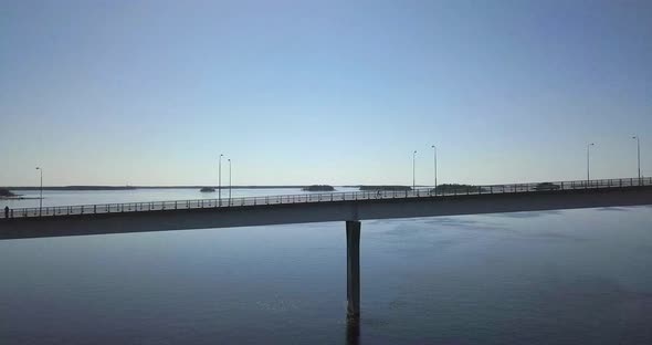 Aerial view of a man crossing a bridge while running