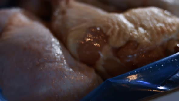 Macro View of a Box Full of Frozen Chicken Legs