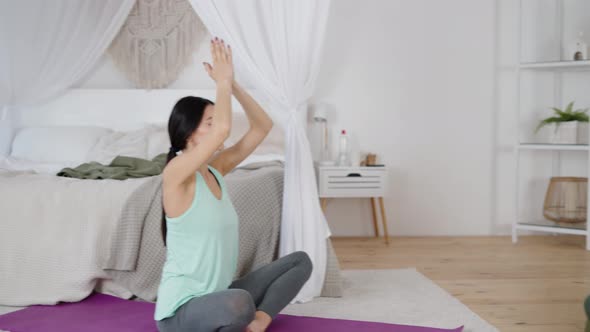 Relaxed Women in Sportswear Meditating in Lotus Position