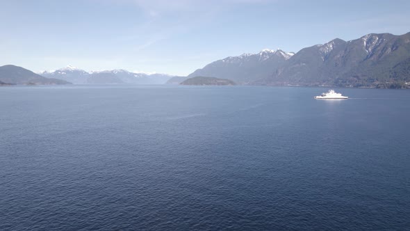 Aerial view of a vessel sailing calm ocean water. British Columbia Ferry Services in Vancouver, crui
