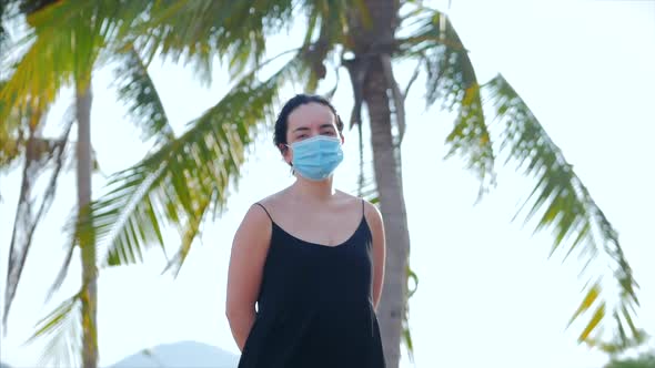 Portrait of Young Woman in a Mask From a Coronavirus Epidemic Wears Protective Demand in the Street