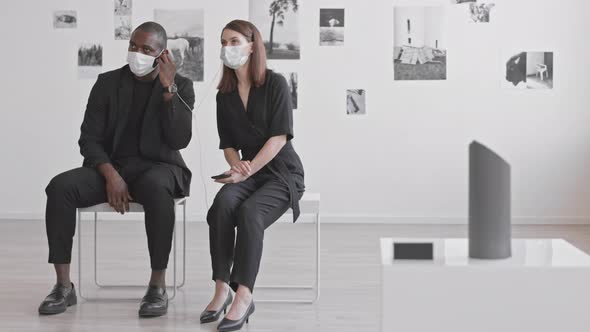 Couple Listening to Audio Guide in Modern Gallery