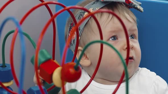 Child Plays with a Multi-colored Toy