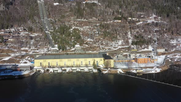 Nore I hydroelectric powerplant operated by Statkraft in Rodberg Norway - Sideways moving sunny day