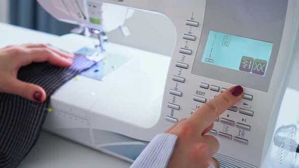 Seamstress Setting Up Sewing Machine with Display