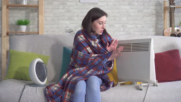 Young Woman Is Freezing in Her Apartment in the Living Room